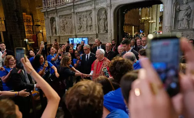 Pope Leo XIV greets people as he leaves after presiding over a midday prayer at the Cathedral of the Holy Cross and Saint Eulalia in Barcelona, Spain, Tuesday, June 9, 2026. (AP Photo/Bernat Armangue)