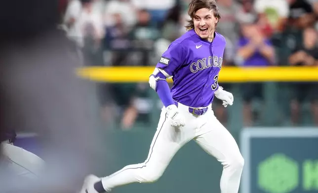 Colorado Rockies' Jake McCarthy celebrates after his three-run walkoff triple off Boston Red Sox relief pitcher Aroldis Chapman in the ninth inning of a baseball game Monday, June 22, 2026, in Denver. (AP Photo/David Zalubowski)