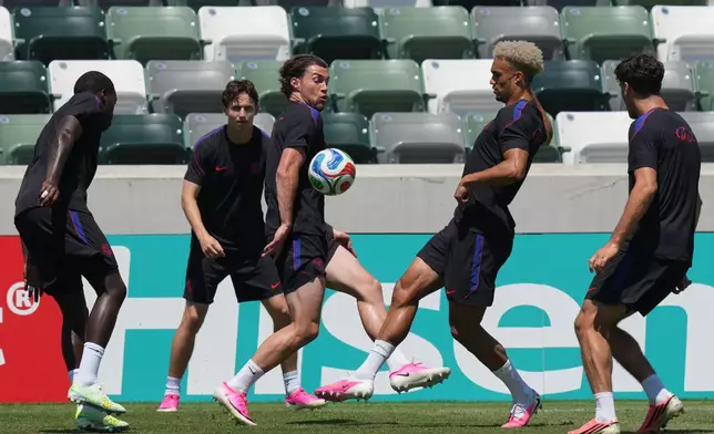 United States' Joe Scally, center, Antonee Robinson, center right, and teammates attend a training session ahead of their FIFA World Cup match against Paraguay at its World Cup soccer tournament training base in Irvine, Calif., Thursday, June 11, 2026. (AP Photo/Andre Penner)
