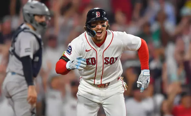 Boston Red Sox's Jarren Duran, right, celebrates in front of New York Yankees catcher Austin Wells, left, after hitting a walk-off one-run single in the tenth inning of a baseball game, Sunday, June 28, 2026, in Boston. (AP Photo/Steven Senne)