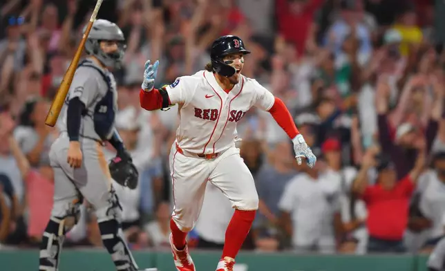 Boston Red Sox's Jarren Duran, right, celebrates in front of New York Yankees catcher Austin Wells, left, after hitting a walk-off one-run single in the tenth inning of a baseball game, Sunday, June 28, 2026, in Boston. (AP Photo/Steven Senne)