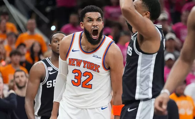 New York Knicks center Karl-Anthony Towns (32) yells during the second half of Game 1 of the NBA Finals basketball series against the San Antonio Spurs, Wednesday, June 3, 2026, in San Antonio. (AP Photo/Eric Gay)