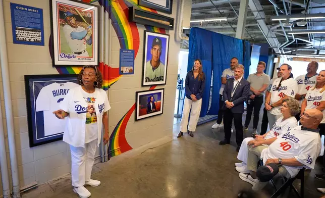 Joyce Henderson, left, sister of Glenn Burke, speaks during a ceremony prior to a baseball game to unveil a tribute to LGBTQ+ trailblazers and former Los Angeles Dodgers players Billy Bean and Burke, who were among the first professional athletes to identify as gay, Friday, June 5, 2026, in Los Angeles. (AP Photo/Mark J. Terrill)