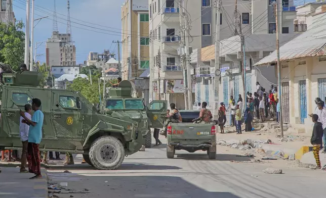 Armored vehicles carrying Somali security forces patrol a street after supporters of opposition political figures and state security forces clashed in Mogadishu, Somalia, Thursday, June 4, 2026. (AP Photo/Farah Abdi Warsameh)