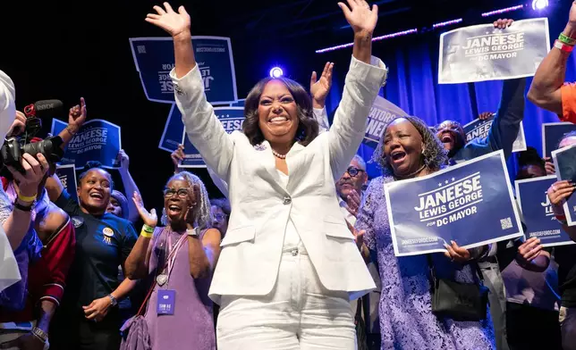 D.C. Council member Janeese Lewis George waves to the crowd as she celebrates after winning D.C. Mayor primary election during an election night party at the Howard Theatre Tuesday, June 16, 2026, in Washington. (AP Photo/Jose Luis Magana)