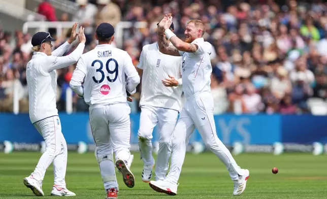 England's captain Ben Stokes, right, celebrates with teammates after the dismissal of New Zealand's Devon Conway during the fourth day of the Test match between England and New Zealand at Lord's cricket ground in London, Sunday, June 7, 2026. (AP Photo/Kirsty Wigglesworth)