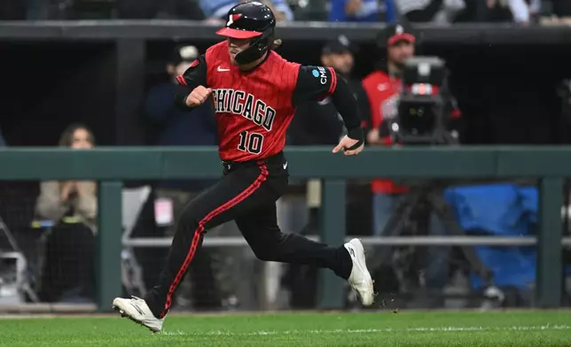 Chicago White Sox's Chase Meidroth runs to home plate while scoring on a Tristan Peters two-run single during the third inning of a baseball game against the Kansas City Royals in Chicago, Friday, June 26, 2026. (AP Photo/Paul Beaty)