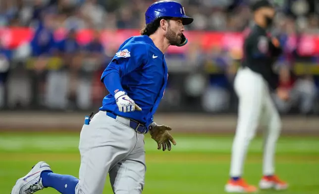 Chicago Cubs' Dansby Swanson runs to first base for a two-run single during the ninth inning in the second baseball game of a doubleheader against the Chicago Cubs Wednesday, June 24, 2026, in New York. (AP Photo/Frank Franklin II)