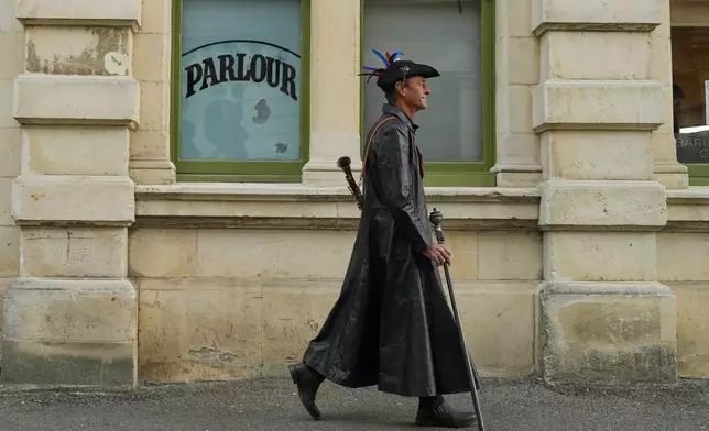 An attendee at the Steampunk NZ Festival walks through the Victorian precinct in Ōamaru, New Zealand, Sunday, May 31, 2026. (AP Photo/Charlotte Graham-McLay)