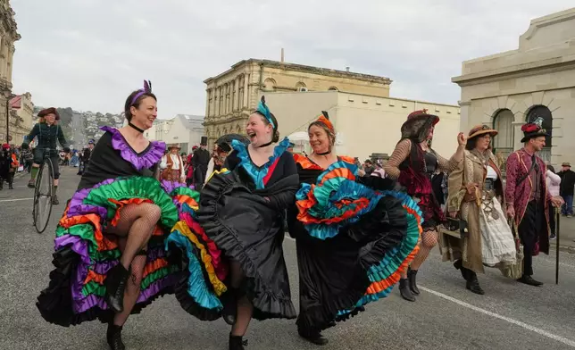 Participants walk in a parade at the Steampunk NZ Festival in Ōamaru, New Zealand, Saturday, May 30, 2026. (AP Photo/Charlotte Graham-McLay)