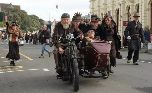 Attendees participate in a parade at the Steampunk NZ Festival in Ōamaru, New Zealand, Saturday, May 30, 2026. (AP Photo/Charlotte Graham-McLay)