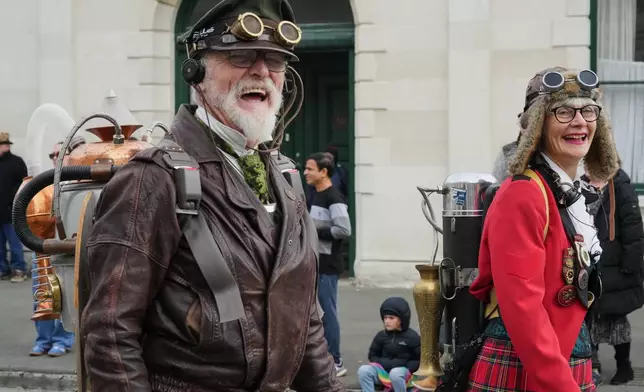 Steampunk NZ Festival co-founders Iain Clark, who goes by Agent Darling, and Helen Jansen walk in a parade at the annual event in Ōamaru, New Zealand, Saturday, May 30 2026. (AP Photo/Charlotte Graham-McLay)