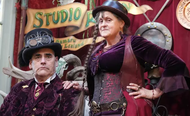 Steampunk NZ Festival attendees Ross McKay and T.S. Taylor, who goes by Miss Purple, pose during the annual event in Ōamaru, New Zealand, Friday, May 29, 2026. (AP Photo/Charlotte Graham-McLay)