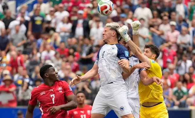 Bosnia goalkeeper Nikola Vasilj, right, clears the ball during the World Cup Group B soccer match between Switzerland and Bosnia in Inglewood, Calif., near Los Angeles, Thursday, June 18, 2026. (AP Photo/Andre Penner)