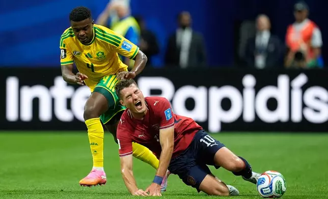 Czechia's Patrik Schick falls to the ground in a clash with South Africa's Teboho Mokoena, left, during the World Cup Group A soccer match between Czechia and South Africa in Atlanta, Thursday, June 18, 2026. (AP Photo/Mike Stewart)
