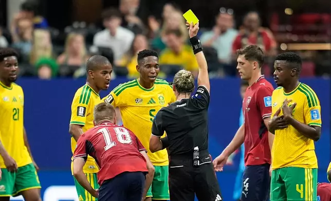 Referee Tori Penso, of the United States, a yellow card to South Africa's Thalente Mbatha, center, during the World Cup Group A soccer match between Czechia and South Africa in Atlanta, Thursday, June 18, 2026. (AP Photo/Mike Stewart)