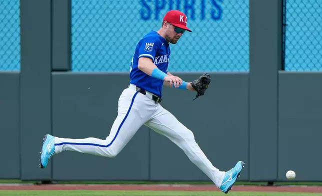 Kansas City Royals right fielder Lane Thomas chases a single hit by St. Louis Cardinals' Alec Burleson during the fifth inning of a baseball game Sunday, June 21, 2026, in Kansas City, Mo. (AP Photo/Charlie Riedel)