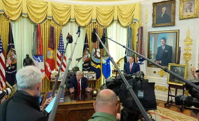 President Donald Trump speaks to reporters as Environmental Protection Agency administrator Lee Zeldin listens in the Oval Office of the White House, Monday, June 29, 2026, in Washington. (AP Photo/Jacquelyn Martin)