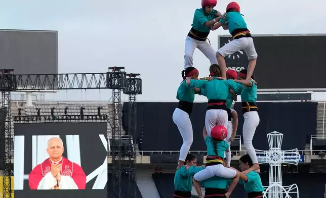 Performers make a human tower, known as Castells, for Pope Leo XIV as he leads a vigil of prayer at the Lluis Companys Olympic Stadium, in Barcelona, Tuesday, June 9, 2026. (AP Photo/Alessandra Tarantino)