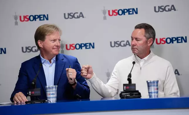 United States Golf Association's President Kevin Hammeron, CEO Mike Whan arrive for a news conference during the U.S. Open golf tournament at Shinnecock Hills Golf Club in Southampton, N.Y., Wednesday, June 17, 2026.(AP Photo/David J. Phillip)