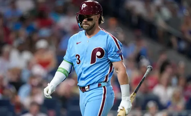 Philadelphia Phillies' Bryce Harper walks to the dugout after striking out against New York Mets pitcher Luke Weaver during the eighth inning of a baseball game Thursday, June 18, 2026, in Philadelphia. (AP Photo/Matt Slocum)
