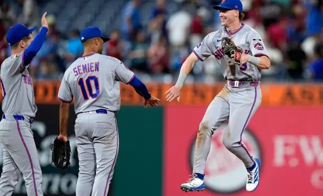 New York Mets' Carson Benge, right, celebrates with Marcus Semien after the Mets won a baseball game against the Philadelphia Phillies Thursday, June 18, 2026, in Philadelphia. (AP Photo/Matt Slocum)