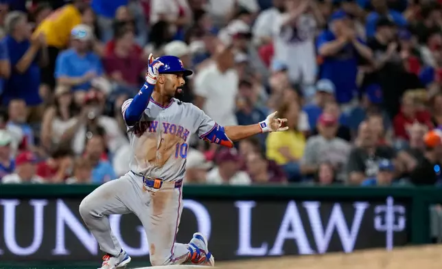 New York Mets' Marcus Semien reacts after hitting a two-run triple against Philadelphia Phillies pitcher José Alvarado during the seventh inning of a baseball game Thursday, June 18, 2026, in Philadelphia. (AP Photo/Matt Slocum)