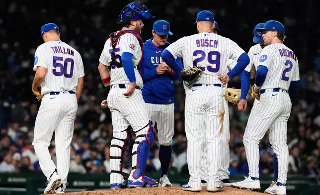 Chicago Cubs manager Craig Counsell, third from left, talks to players after he pulled starting pitcher Jameson Taillon, left, during the seventh inning of a baseball game against the Athletics in Chicago, Tuesday, June 2, 2026. (AP Photo/Nam Y. Huh)