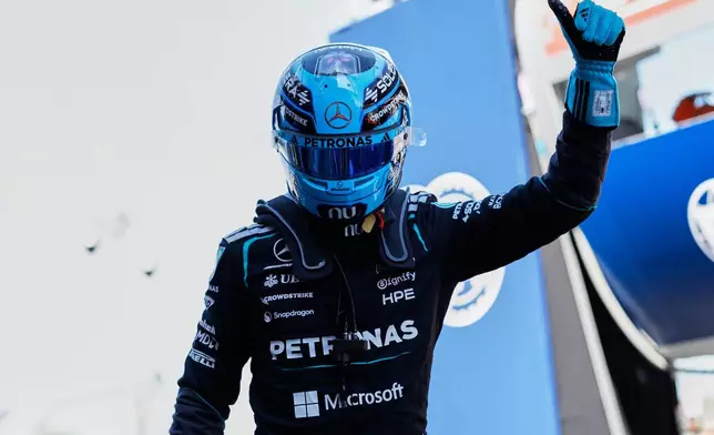 Mercedes driver George Russell of Britain celebrates his pole position after qualifying session for the Spain F1 Grand Prix at the Barcelona Catalunya racetrack in Montmelo, near Barcelona, Spain, Saturday, June 13, 2026. (AP Photo/Joan Monfort)