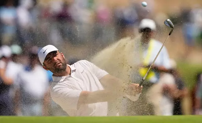 Scottie Scheffler hits from the bunker on the second hole during the third round of the U.S. Open golf tournament at Shinnecock Hills Golf Club in Southampton, N.Y., Saturday, June 20, 2026.(AP Photo/Gerald Herbert)