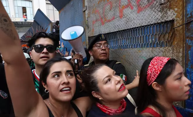 Fans funnel their way through a barricade to a fan festival area to watch the World Cup Group A soccer match between Mexico and South Africa in Mexico City, Thursday, June 11, 2026. (AP Photo/Ashtin Barker)