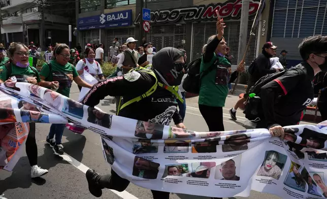 Relatives of Mexico's disappeared and protesters march before the opening day of the 2026 FIFA World Cup in Mexico City, Thursday, June 11, 2026. (AP Photo/Alejandro Cegarra)