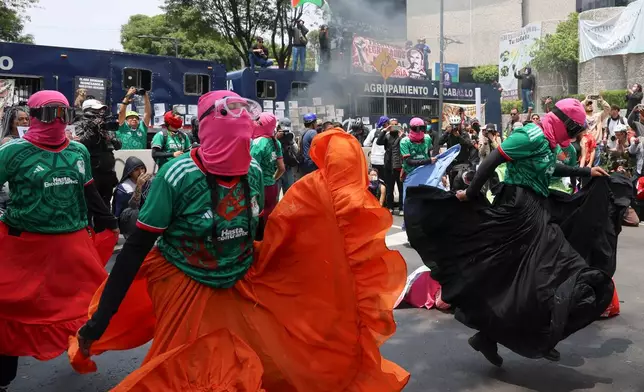 Demonstrators perform during a march protesting prior to the opening day of the 2026 FIFA World Cup in Mexico City, Thursday, June 11, 2026. (AP Photo/Ginnette Riquelme)