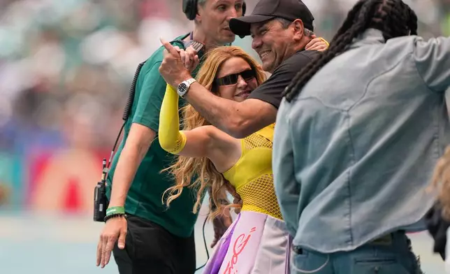 Colombian artist Shakira dances with her brother Antonio Mebarak while waiting to perform during the opening ceremony before the start of the World Cup Group A soccer match between Mexico and South Africa in Mexico City, Thursday, June 11, 2026. (AP Photo/Natacha Pisarenko)