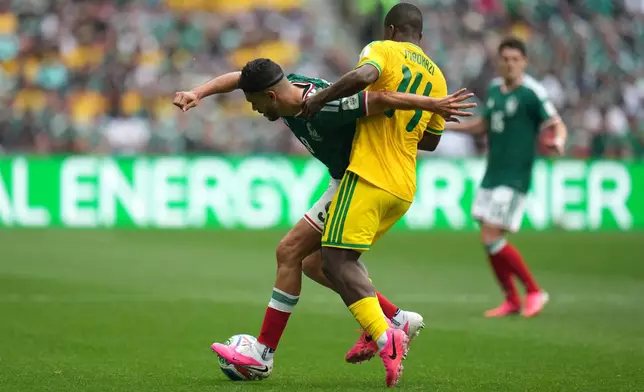 Mexico's Raul Jimenez, left, controls the ball against South Africa's Mbekezeli Mbokazi during the World Cup Group A soccer match between Mexico and South Africa in Mexico City, Thursday, June 11, 2026. (AP Photo/Eduardo Verdugo)