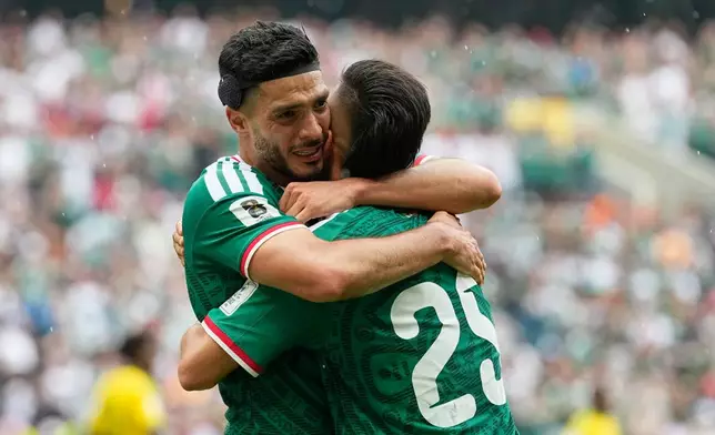 Mexico's Raul Jimenez hugs teammate Roberto Alvarado, right, after scoring his side's second goal during the World Cup Group A soccer match between Mexico and South Africa in Mexico City, Thursday, June 11, 2026. (AP Photo/Natacha Pisarenko)