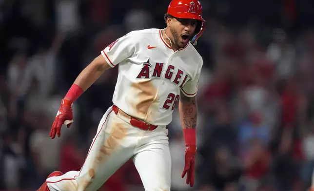 Los Angeles Angels Jose Siri celebrates his game-winning single against the Houston Astros during the 10th inning of a baseball game Wednesday, June 10, 2026, in Anaheim, Calif. (AP Photo/Scott Strazzante)