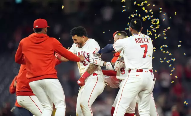 Los Angeles Angels Jose Siri celebrates with teammates after his game-winning single against the Houston Astros during the tenth inning of a baseball game, Wednesday, June 10, 2026, in Anaheim, Calif. (AP Photo/Scott Strazzante)