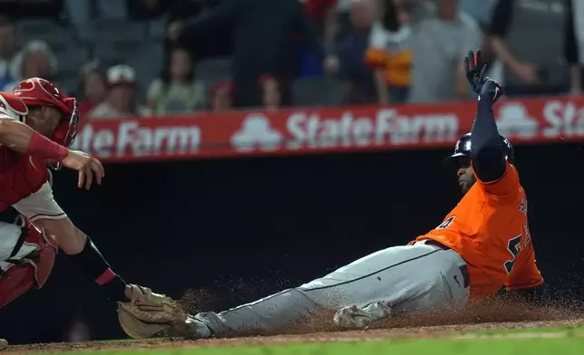 Houston Astros Yordan Alvarez (44) is tagged out by Los Angeles Angels catcher Logan O'Hoppe at home plate during the ninth inning of a baseball game Wednesday, June 10, 2026, in Anaheim, Calif. (AP Photo/Scott Strazzante)