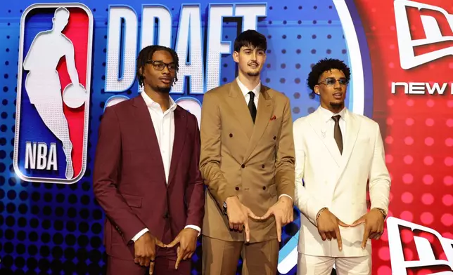 Morez Johnson Jr., from left, Aday Mara and Yaxel Lendeborg arrive for the first round of the NBA basketball draft Tuesday, June 23, 2026, in New York. (AP Photo/Adam Hunger)