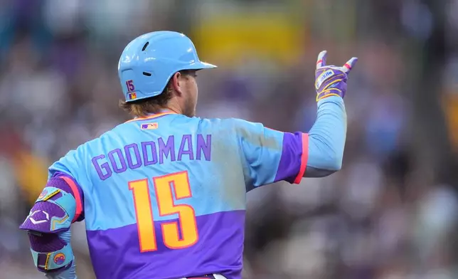 Colorado Rockies' Hunter Goodman gestures to the bullpen as he circles the bases after hitting a solo home run off Milwaukee Brewers starting pitcher Brandon Sproat in the third inning of a baseball game Friday, June 5, 2026, in Denver. (AP Photo/David Zalubowski)