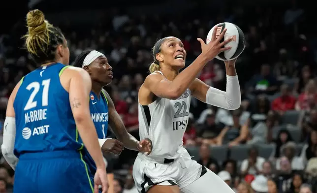 Las Vegas Aces center A'ja Wilson (22) shoots against Minnesota Lynx forward Natasha Howard (1) during the first half of a WNBA basketball game Saturday, June 13, 2026, in Las Vegas. (AP Photo/John Locher)