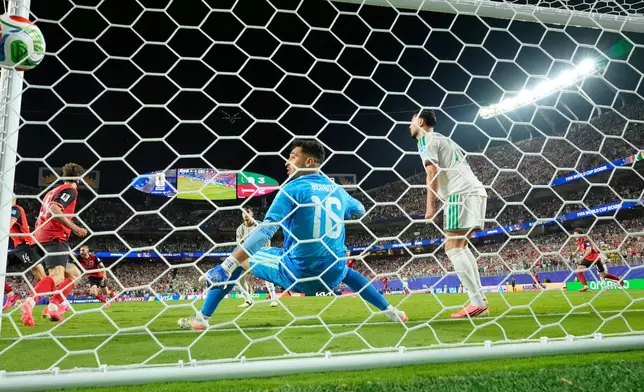Algeria goalkeeper Oussama Benbot (16) looks a back at the ball in the goal after Austria's Sasa Kalajdzic (14) scored a third goal during the World Cup Group J soccer match between Algeria and Austria in Kansas City, Mo., Saturday, June 27, 2026. (AP Photo/Reed Hoffmann)