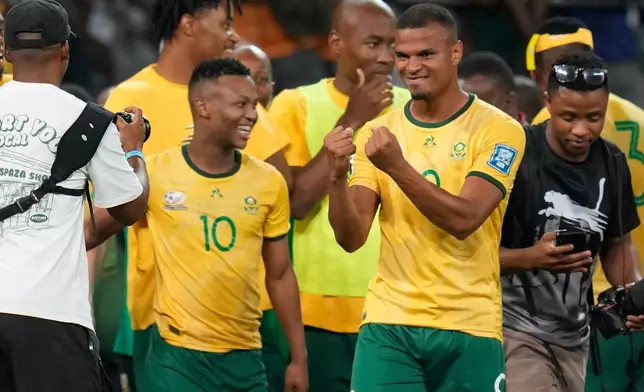 FILE - South Africa players celebrate after a World Cup 2026 group C qualifying soccer match between South Africa and Rwanda at Mbombela Stadium, in Nelspruit, South Africa, Oct. 14, 2025. (AP Photo/Themba Hadebe, File)