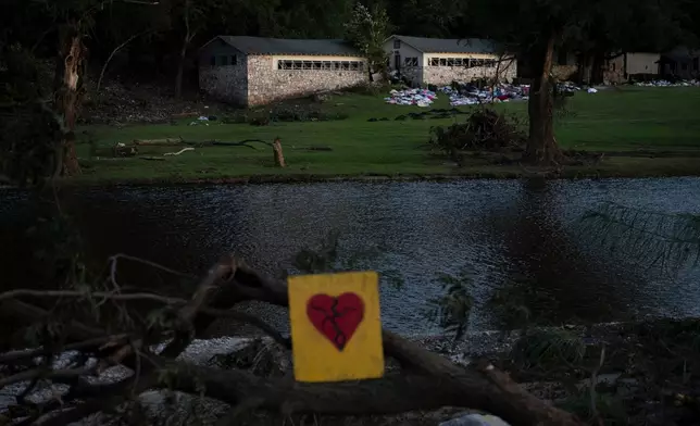 FILE - A broken heart sign is displayed near Camp Mystic on Tuesday, July 8, 2025, after a flash flood swept through the area in Hunt, Texas. (AP Photo/Eli Hartman, file)