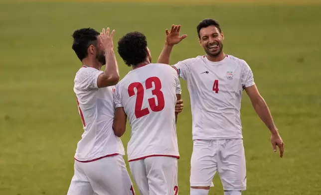Iran's Ramin Rezaeian, center, celebrates with teammates after scoring their side's second goal during a friendly soccer match between Iran and Gambia, in Antalya, southern Turkey, Friday, May 29, 2026. (AP Photo/Khalil Hamra)