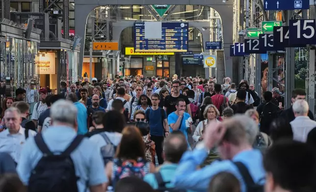 Passengers are on the move in the central train station in Frankfurt, Germany, Wednesday, June 24, 2026, following the nationwide service disruption on the Deutsche Bahn network. (AP Photo/Michael Probst)