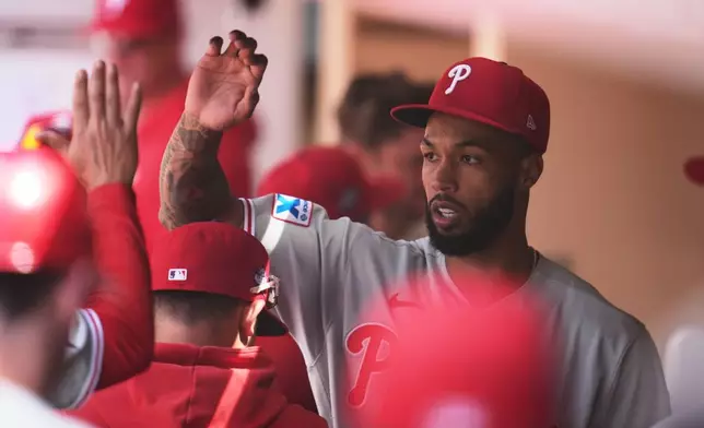Philadelphia Phillies starting pitcher Cristopher Sánchez celebrates in the dugout after the last out of the seventh inning of a baseball game against the San Diego Padres Wednesday, May 27, 2026, in San Diego. (AP Photo/Gregory Bull)