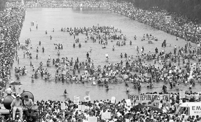 FILE - Many supporters of the Poor People's Campaign wade into the Reflecting Pool during the Solidarity Day program at the Lincoln Memorial in Washington June 19, 1968. (AP Photo)