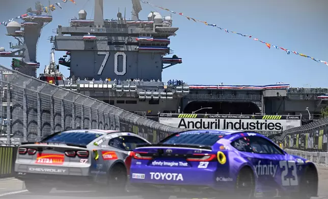 Shane Van Gisbergen (97) and Bubba Wallace (23) come out of Turn 2 during a NASCAR Cup Series auto race, Sunday, June 21, 2026, in Coronado, Calif. (AP Photo/Denis Poroy)